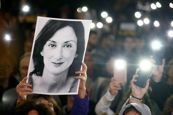 People gather at the Great Siege Square calling for the resignation of Joseph Muscat following the arrest of one of the country's most prominent businessmen as part of the investigation into the murder of journalist Daphne Caruana Galizia, in Valletta, Ma