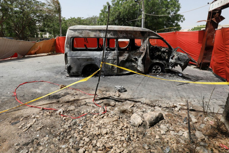 A view of the crater and cordoned area near a damaged passenger van, a day after a suicide blast, at the entrance of the Confucius Institute University of Karachi, Pakistan April 27, 2022. 