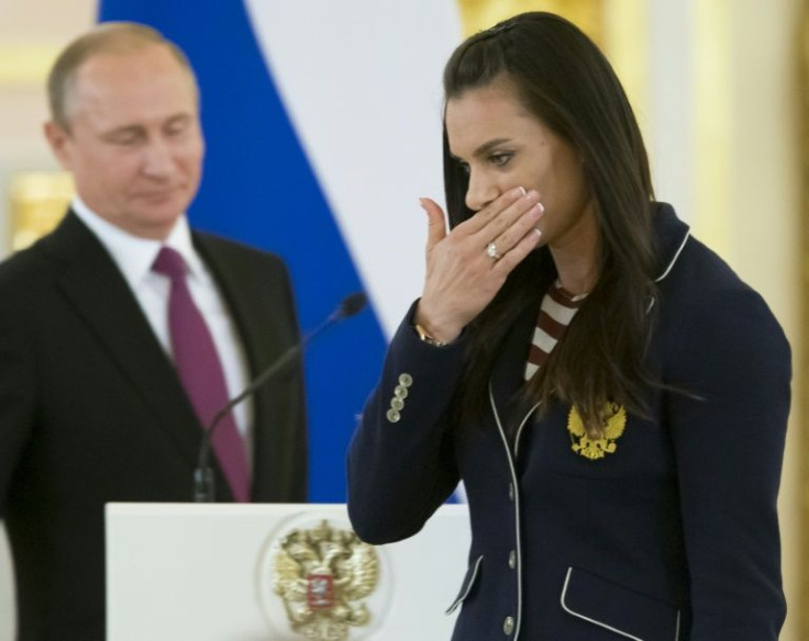 Russian pole vaulter Yelena Isinbayeva, a member of the International Olympic Committee, wipes a tear during a reception by President Vladimir Putin for Olympic athletes at the Kremlin in July 2016