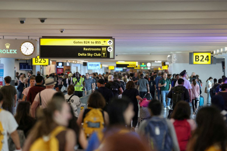 People walk toward their gates as they travel from John F. Kennedy International Airport on the July 4th weekend in Queens, New York City, U.S., July 2, 2022.