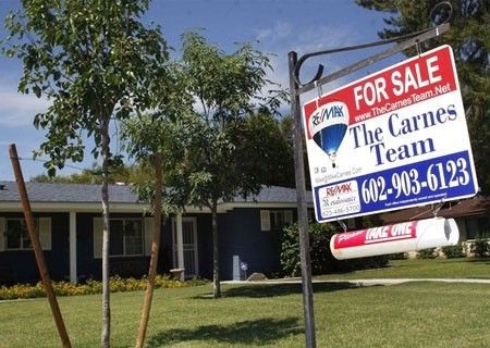 A real estate sales sign sits outside of a house for sale in Phoenix, Arizona June 2, 2009