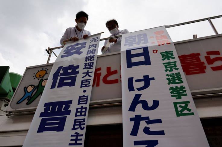 Election campaign members of the ruling Liberal Democratic Party prepare for the campaign speech by a candidate on top of a campaign van ahead of the July 10, 2022 Upper House election, in Tokyo, Japan June 22, 2022.  