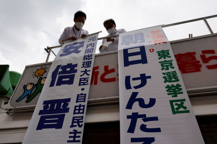 Election campaign members of the ruling Liberal Democratic Party prepare for the campaign speech by a candidate on top of a campaign van ahead of the July 10, 2022 Upper House election, in Tokyo, Japan June 22, 2022.