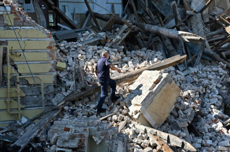 A resÑuer works among ruins of an administrative building destroyed by Russian missiles in the northeastern Ukrainian city of Kharkiv
