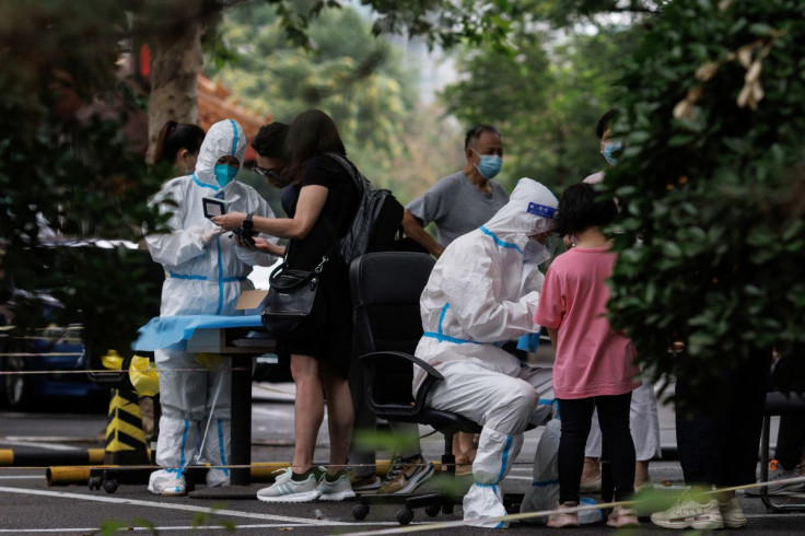 Medical workers register people at a nucleic acid testing station, following a coronavirus disease (COVID-19) outbreak, in Beijing, China, July 6, 2022.