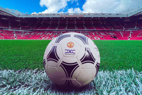 A football showing Manchester United and DXC logos lies on the ground of Old Trafford stadium in  Manchester, Britain June 29, 2022. DXC/Handout via REUTERS 