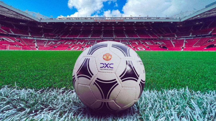 A football showing Manchester United and DXC logos lies on the ground of Old Trafford stadium in  Manchester, Britain June 29, 2022. DXC/Handout via REUTERS 