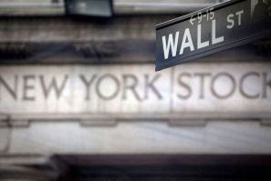 A Wall Street sign is pictured outside the New York Stock Exchange in New York, October 28, 2013. 
