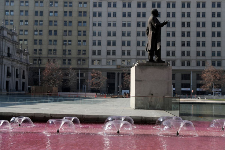 Water with red pigment is seen outside the government palace during a rally as the constitutional assembly leads the delivery ceremony of the final draft of the new constitution in Santiago, Chile July 4, 2022.
