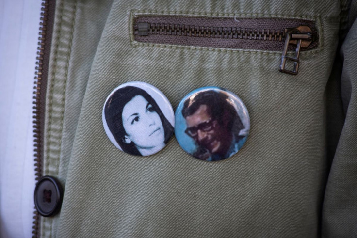 Veronica Castelli wears buttons with pictures of her parents who disappeared during Argentina's military dictatorship, at a court hearing where prison sentences were handed out to former military officers for crimes committed in a clandestine detention ce