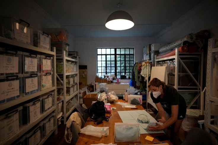 Heather Kaye, 48, works before leaving China for the U.S., at her swimsuit studio in Shanghai, China June 10, 2022. When Kaye moved to Shanghai to work for a fashion label, she became enthralled by the fast charging energy of a China on the rise and decid