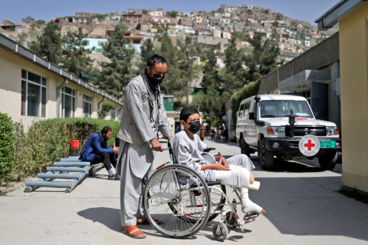 Ahmad Zia, 17, who lost his leg in a magnetic mine in a car, is seen with his uncle at the Red Cross rehabilitation center in Kabul, Afghanistan, April 9, 2022. 