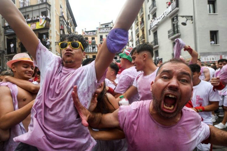 Festival-goers traditionally wear all-white clothing with a red neckscarf, although everyone's garments are soon stained with red wine and sangria