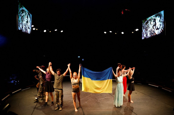Ukrainian artists of the zirka ! troupe hold an Ukrainian flag at the end of their circus show, a performance to raise awareness with circus art the consequences of the Russia's invasion of Ukraine, in Saumur, France July 6, 2022.