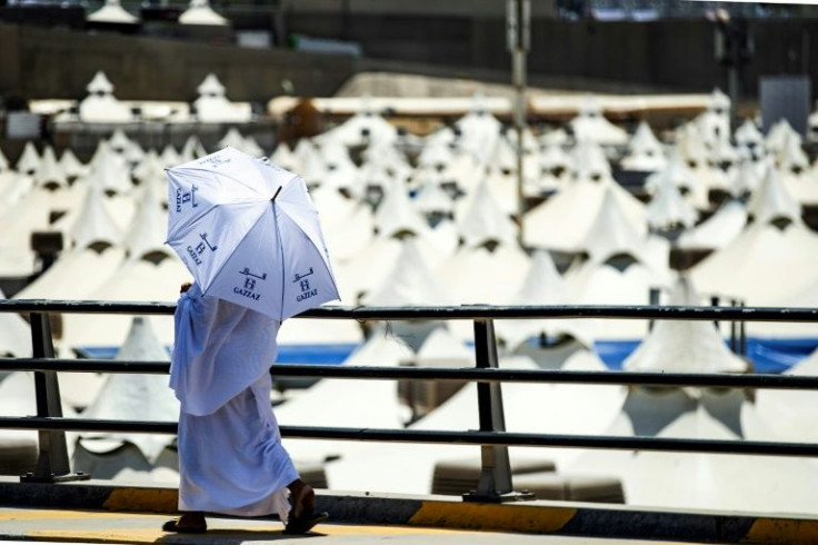 A Muslim pilgrim walks past the air-conditioned tents at the camp in Mina