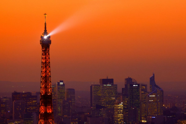 A view at sunset shows the Eiffel Tower and the financial and business district of La Defense in Puteaux near Paris, France, February 9, 2022. 