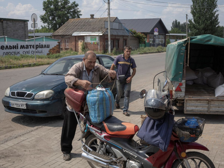 A man packs his belongings on a motorcycle in Sloviansk, Donetsk region, Ukraine July 5, 2022.