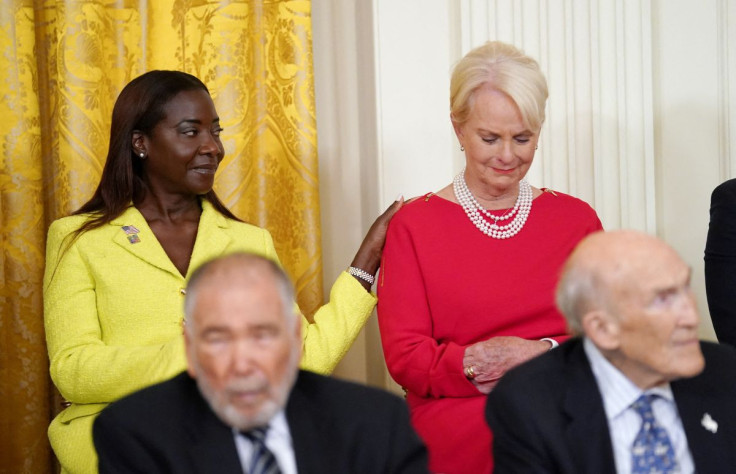 Cindy McCain is comforted by Presidential Medal of Freedom recipient Sandra Lindsay, the first American to receive a COVID-19 vaccine, as U.S. President Joe Biden reads the citation for Senator John McCainâs posthumous Presidential Medal of Freedom duri