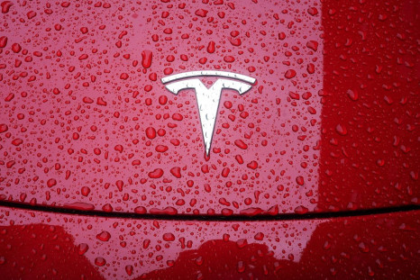 A Tesla logo is pictured on a car in the rain in the Manhattan borough of New York City, New York, U.S., May 5, 2021. 