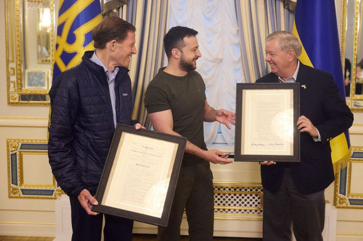 U.S. Senators Lindsey Graham (R-SC) and Richard Blumenthal (D-CT) exchange framed documents at a meeting with Ukraine's President Volodymyr Zelenskiy, as Russia's attack on Ukraine continues, in Kyiv, Ukraine July 7, 2022. Ukrainian Presidential Press Ser