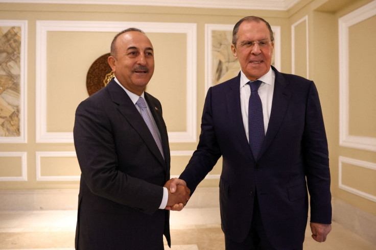 Russian Foreign Minister Sergei Lavrov and Turkish Foreign Minister Mevlut Cavusoglu shake hands as they meet in Denpasar, Indonesia July 7, 2022. Russian Foreign Ministry/Handout via REUTERS