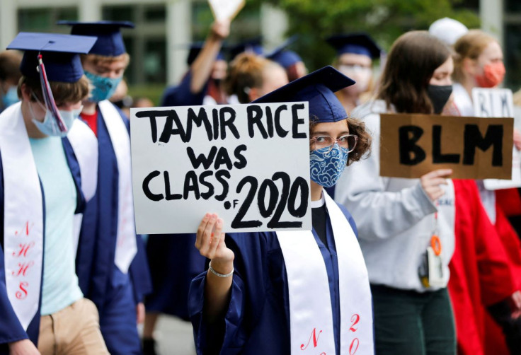 Senior Ruby Wilson holds a sign saying that Tamir Rice, killed by Cleveland Police in 2014, would have been a 2020 graduate as Nathan Hale High School seniors join with others to protest against racial inequality in the aftermath of the death in Minneapol