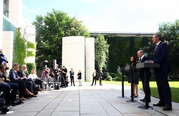 German Chancellor Olaf Scholz, chairman of the Confederation of German Employers' Association (BDA) Rainer Dulger and chairwoman of Federation of Trade Unions (DGB) Yasmin Fahimi give a statement in Berlin, Germany, July 4, 2022.