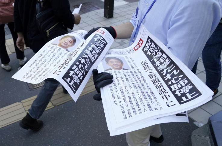 Copies of an extra edition of a newspaper is handed out to pedestrians in Sapporo, after former Japanese Prime Minister Shinzo Abe was shot, in Sapporo, Japan July 8, 2022 in this photo taken by Kyodo. Kyodo via REUTERS
