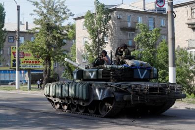 Service members of pro-Russian troops ride a tank during Ukraine-Russia conflict in the town of Popasna in the Luhansk Region, Ukraine June 2, 2022. 