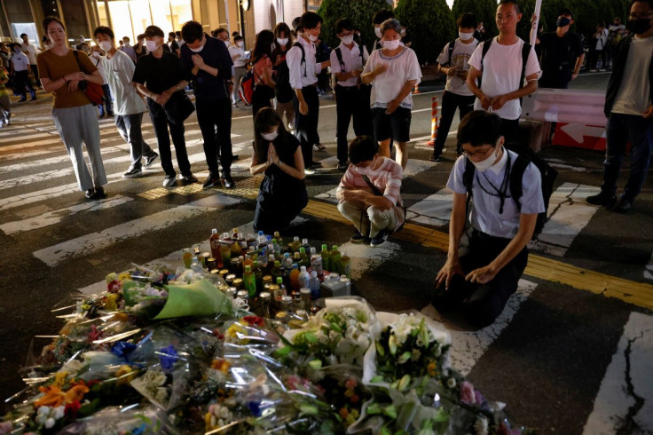 People pay respects at the site where late former Japanese Prime Minister Shinzo Abe was shot while campaigning for a parliamentary election, near Yamato-Saidaiji station in Nara, western Japan, July 8, 2022.