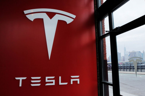 A Tesla logo is painted on a wall inside of a Tesla dealership in New York, U.S., April 29, 2016. 