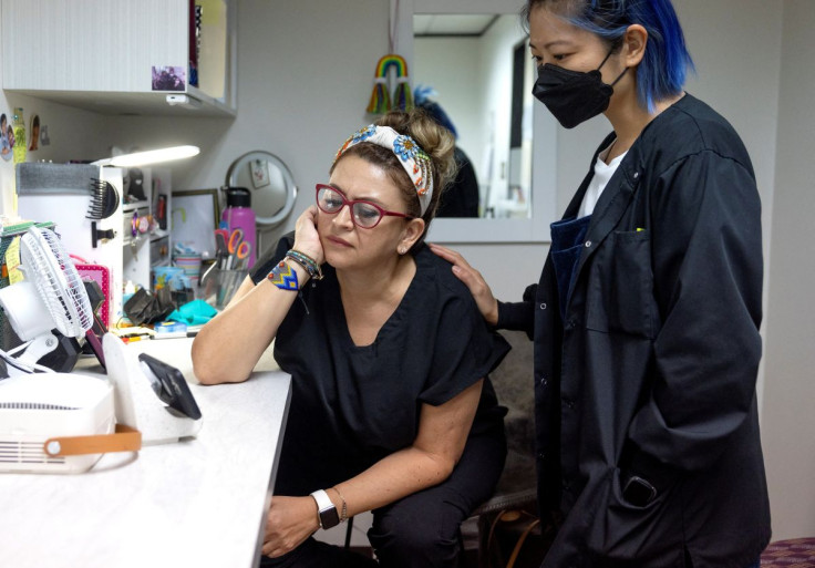 Catalina Leona and Terri Chen, staff at Houston Women's Reproductive Services, which no longer provides abortion care, watch a livestream of U.S. President Joe Biden delivering remarks before signing an executive order which seeks to safeguard abortion ac