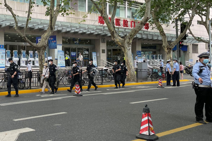 Police officers walk outside the outpatient department of Ruijin Hospital following a stabbing incident, in Shanghai, China July 9, 2022. 