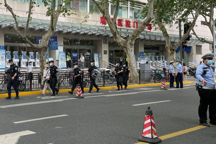 Police officers walk outside the outpatient department of Ruijin Hospital following a stabbing incident, in Shanghai, China July 9, 2022.
