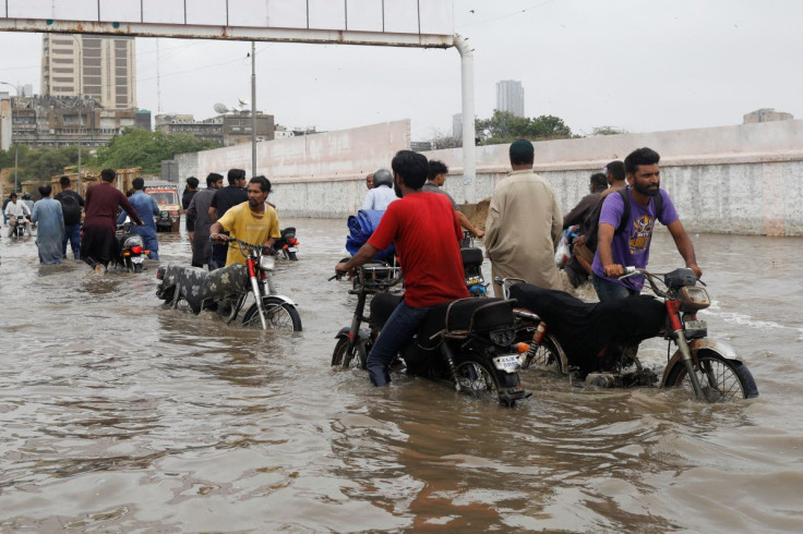 Residents commute through a flooded road during the monsoon season in Karachi, Pakistan July 9, 2022.
