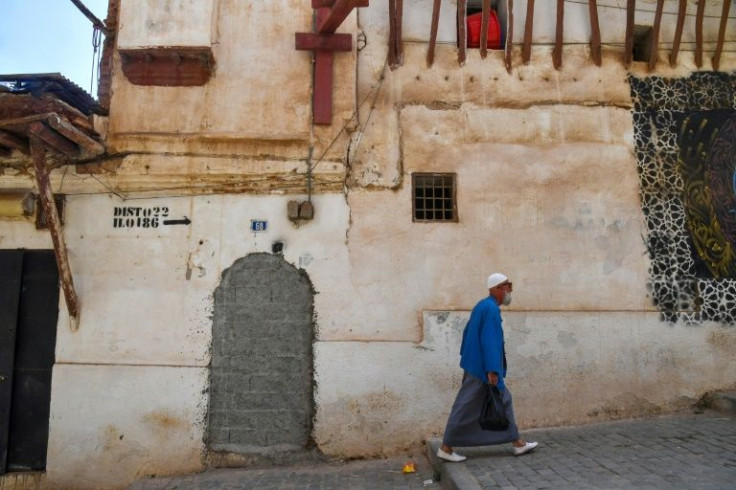 A man walks down a street in the Casbah historic district of Algiers