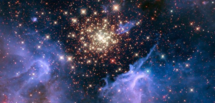 A cluster of young stars resembles an aerial burst, surrounded by clouds of interstellar gas and dust, in a nebula NGC 3603 located in the constellation Carina, in this image captured in August 2009 and December 2009, and obtained September 26, 2018. NASA