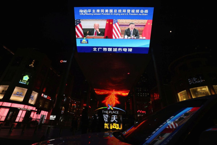 A screen displays a CCTV state media news broadcast showing Chinese President Xi Jinping and U.S. President Joe Biden during a virtual summit, in Beijing, China November 16, 2021.