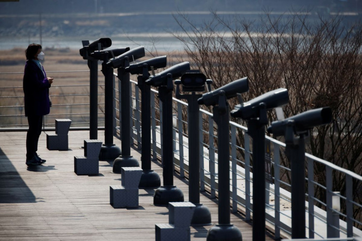 A woman looks toward the north at an observatory platform near the demilitarized zone separating the two Koreas in Paju, South Korea, March 24, 2021.