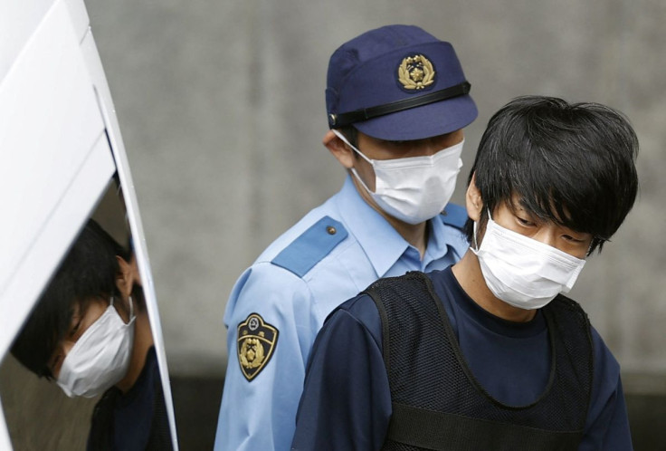 Tetsuya Yamagami, suspected of killing former Japanese Prime Minister Shinzo Abe, is escorted by a police officer as he is taken to prosecutors, at Nara-nishi police station in Nara, western Japan, in this photo taken by Kyodo July 10, 2022. Mandatory cre