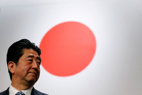 Japan's Prime Minister Shinzo Abe stands in front of Japan's national flag after his ruling Liberal Democratic Party's (LDP) annual party convention in Tokyo, Japan, March 5, 2017. 