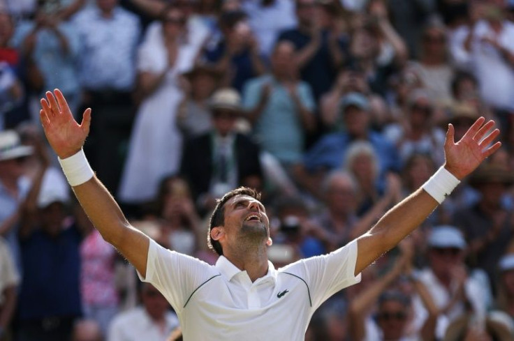 Novak Djokovic celebrates winning a seventh Wimbledon title
