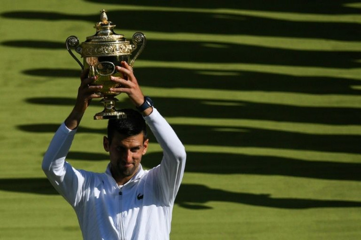 Novak Djokovic lifts the Wimbledon trophy as he celebrates his 21st Grand Slam triumph