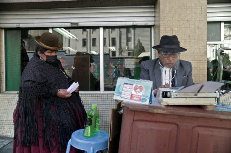 For a fee of up to seven bolivianos (about $1) per page, 'we handle everything related to national taxes,' Rogelio Condori (R) told AFP