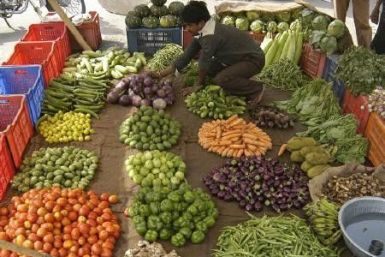 A vendor arranges vegetables at a market in Lucknow in this May 6, 2010 file photo. 