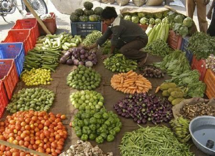 A vendor arranges vegetables at a market in Lucknow in this May 6, 2010 file photo. 