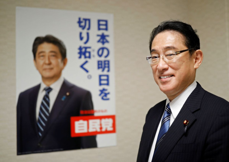 Fumio Kishida, policy chief of Japan's ruling Liberal Democratic Party (LDP) and former foreign minister, who has declared his candidacy for the party leadership election to choose the successor of Prime Minister Shinzo Abe, poses for a photograph next to