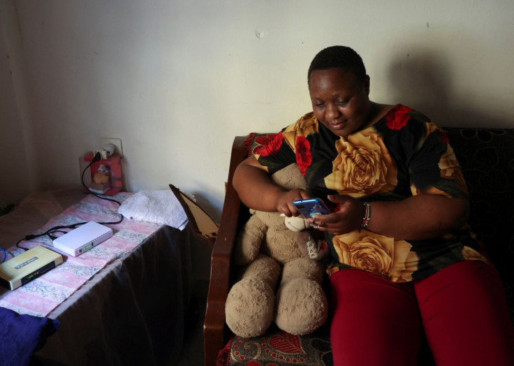 Kenyan migrant worker, Noel Musanga, uses her mobile phone during an interview with Reuters, in her apartment in Burj Hammoud, Lebanon July 1, 2022.