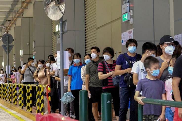 Residents wearing face masks line up to get tested for the coronavirus disease (COVID-19) in Macau, China July 4, 2022.