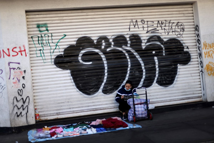 A street hawker sits next to her wares in Santiago, Chile July 7, 2022. 